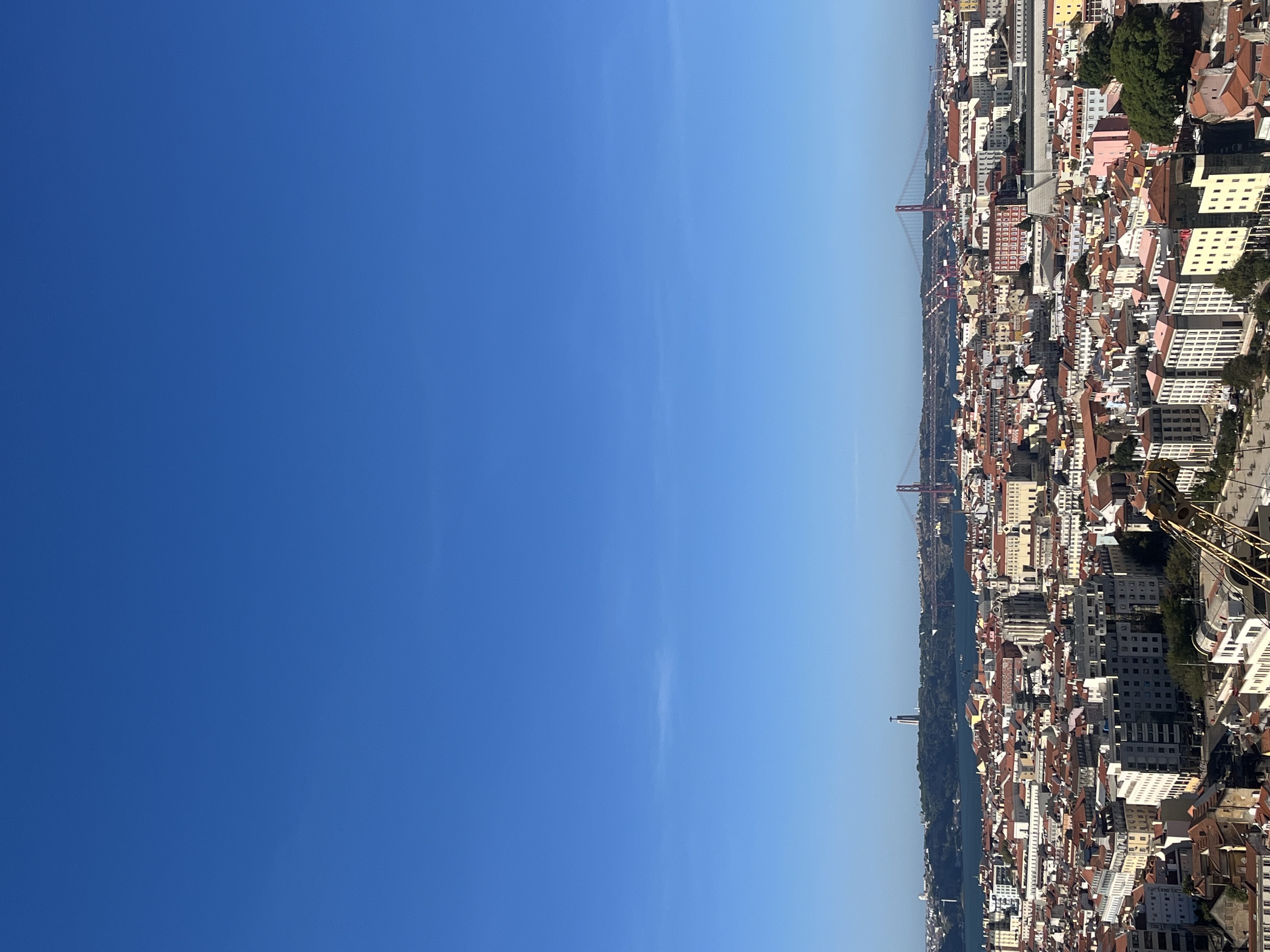Panoramic view over Lisbon rooftops with the Tagus River and bridge